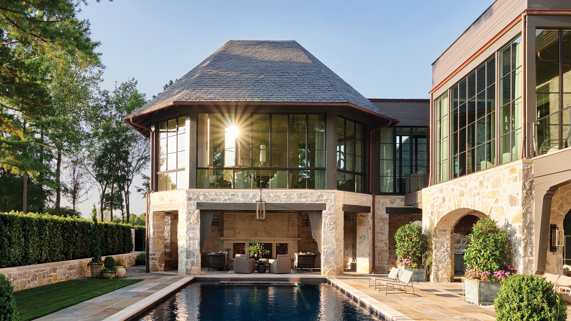 Hope's windows featured on a high-end home surrounded by an outdoor pool and plants.
