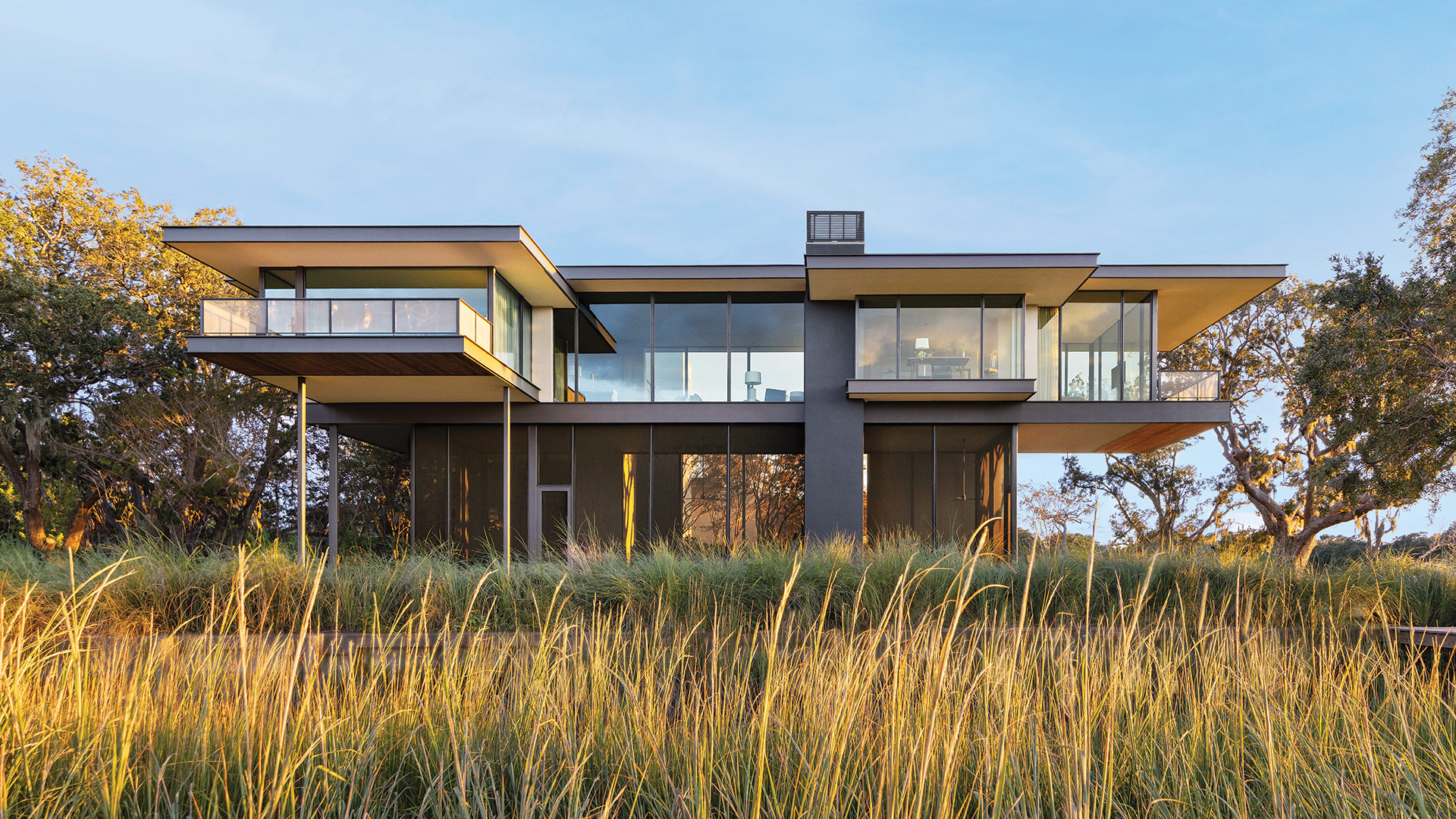 Hope's windows featured on a high-end home surrounded by an outdoor pool and plants.