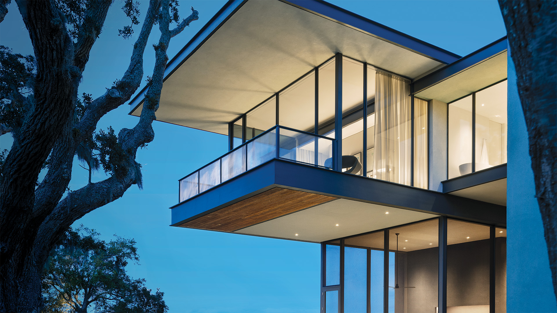 Hope's windows featured on a high-end home surrounded by an outdoor pool and plants.