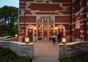 College campus, photo at dusk, displaying hopes windows and doors, college students walking.