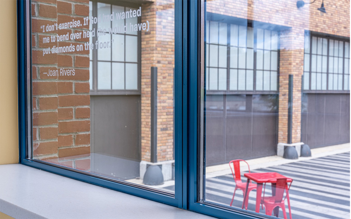 “Jokes with a View” in the National Comedy Center's connector wing, featuring Hope’s steel windows with quotes and one-liners from famous comedians etched into the glass