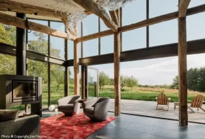 Large open concept farmhouse incorporates nature and modern interiors with Hopes Landmark175 Series and 5000 series windows and doors.