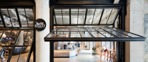 Interior view of the Time Out Market, located in Boston, highlighting counterweight system and manually operable bi-fold doors provided by Hope’s Windows