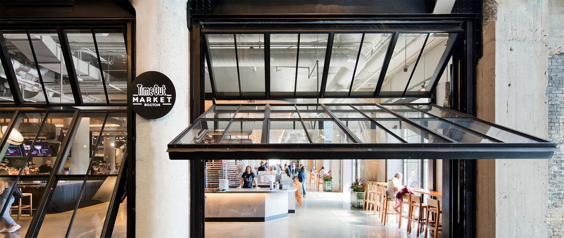 Interior view of the Time Out Market, located in Boston, highlighting counterweight system and manually operable bi-fold doors provided by Hope’s Windows