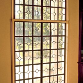 Antique steel windows and doors, interior view looking through leaded glass.