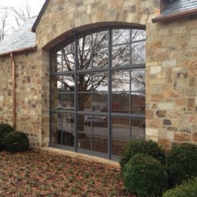 Hope’s custom arched steel window in stone building
