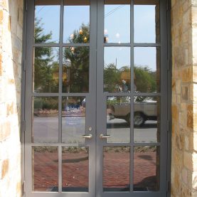 Stone bank building with Hopes steel doors, true divided lites, exterior front entrance view, Iberia-Bank.