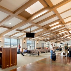 Passengers accessing wide views of the airport runway through Hopes steel windows, located in Santa Barbara, CA.