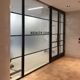 Modern interior glass walls made of Hopes steel windows and doors in an upscale health club.