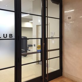 Modern interior glass walls made of Hopes steel windows and doors in an upscale Health Club, Health Club entrance.