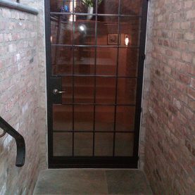 Hopes vintage-style custom arched steel door with beveled profiles, interior view on a private residence located in Illinois.