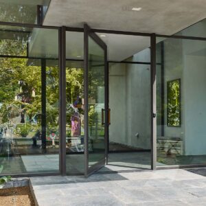 Hopes Windows Jamestown175 Series steel pivot doors displayed in a modern entry way.